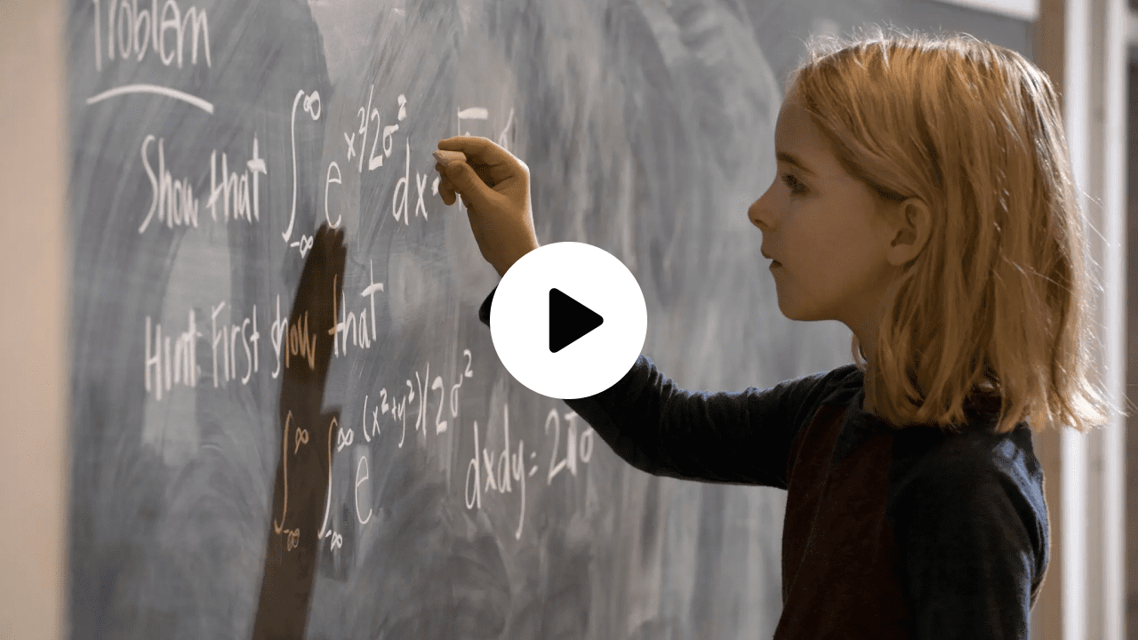 Scene from Gifted featuring a young girl solving an advanced math problem on a chalkboard