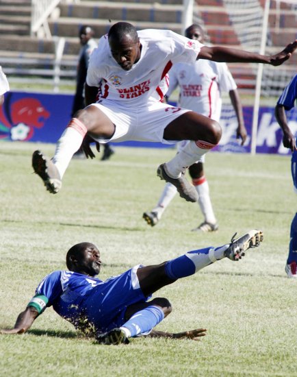 apaka skipper James Situma tackles Ulinzi Star Hussein Mohammed during the charity match at Nyayo Stadium.